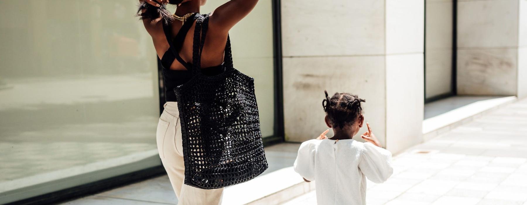 a woman walking with her child