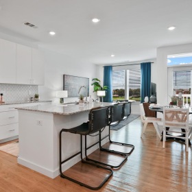 Wide open living areas perfect for entertaining a kitchen with white cabinets