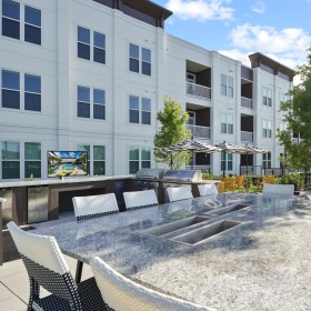 The essence of exceptional living a building with tables and chairs outside